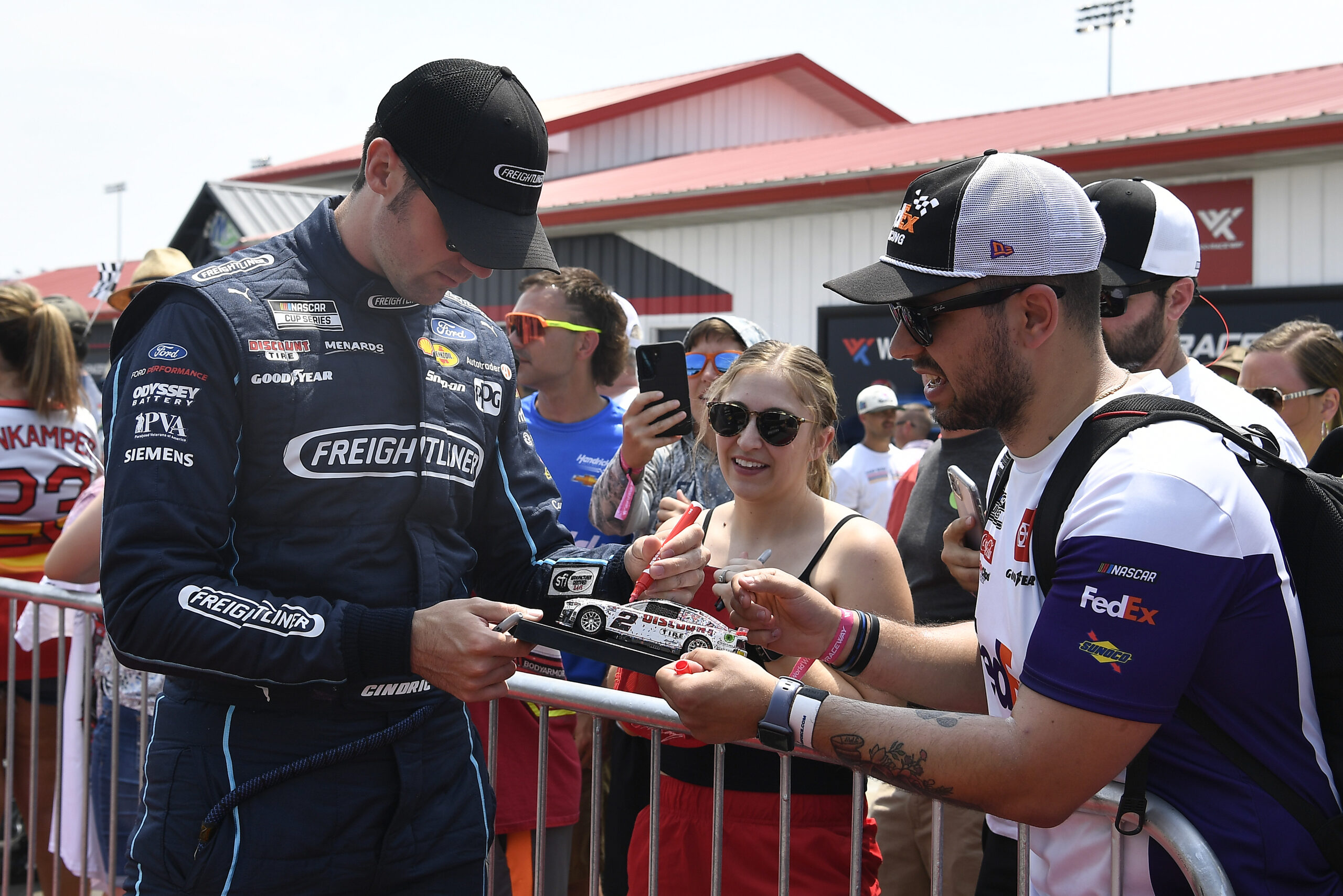 MADISON, IL - JUNE 04: Austin Cindric (#2 Team Penske Freightliner Ford) signs a die cast car before the NASCAR Cup Series Enjoy Illinois 300 on June 4, 2023, at World Wide Technology Raceway at Gateway in Madison, Illinois. (Photo by Michael Allio/Icon Sportswire)